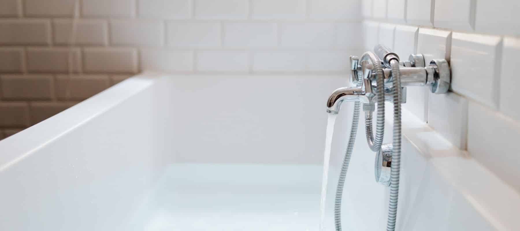 bathtub with running water filling it up