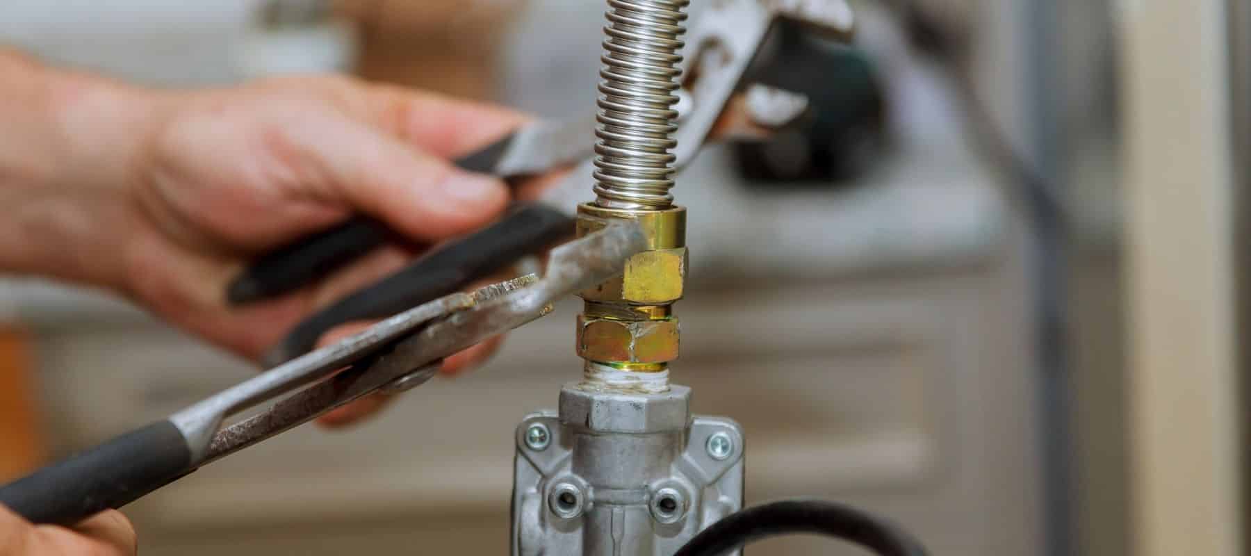 gas line plumber adjusting a bolt