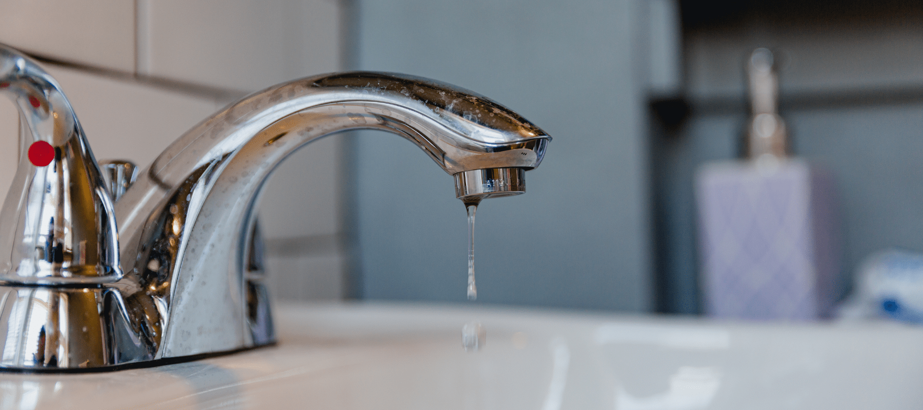 closeup of a water faucet with water dripping out of it