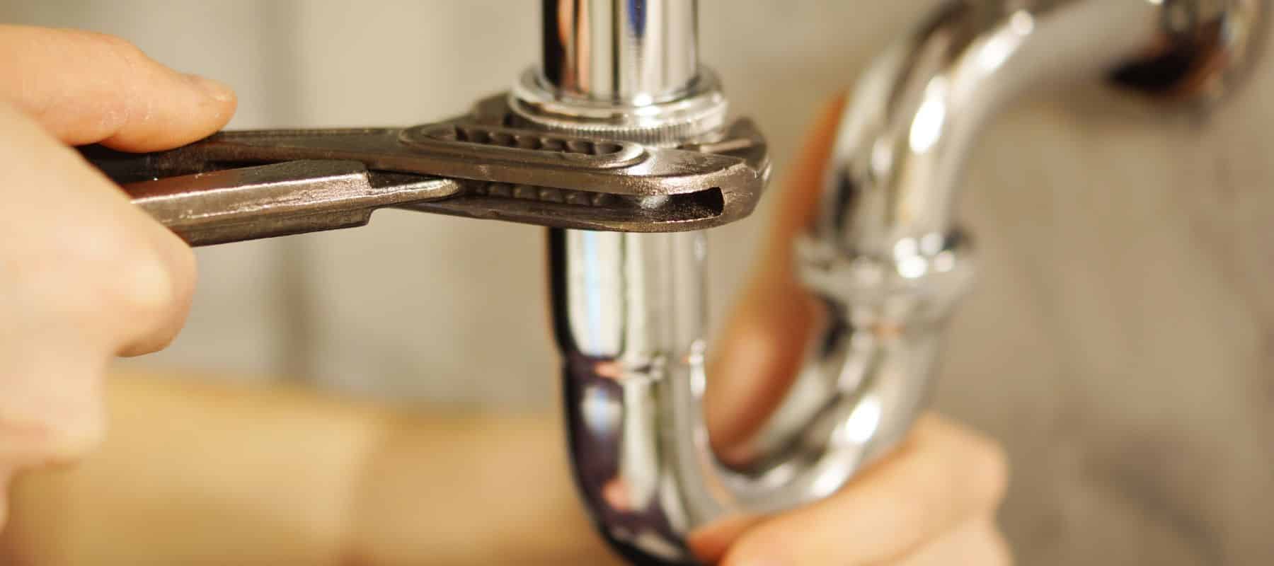 Adjusting plumbing with a wrench